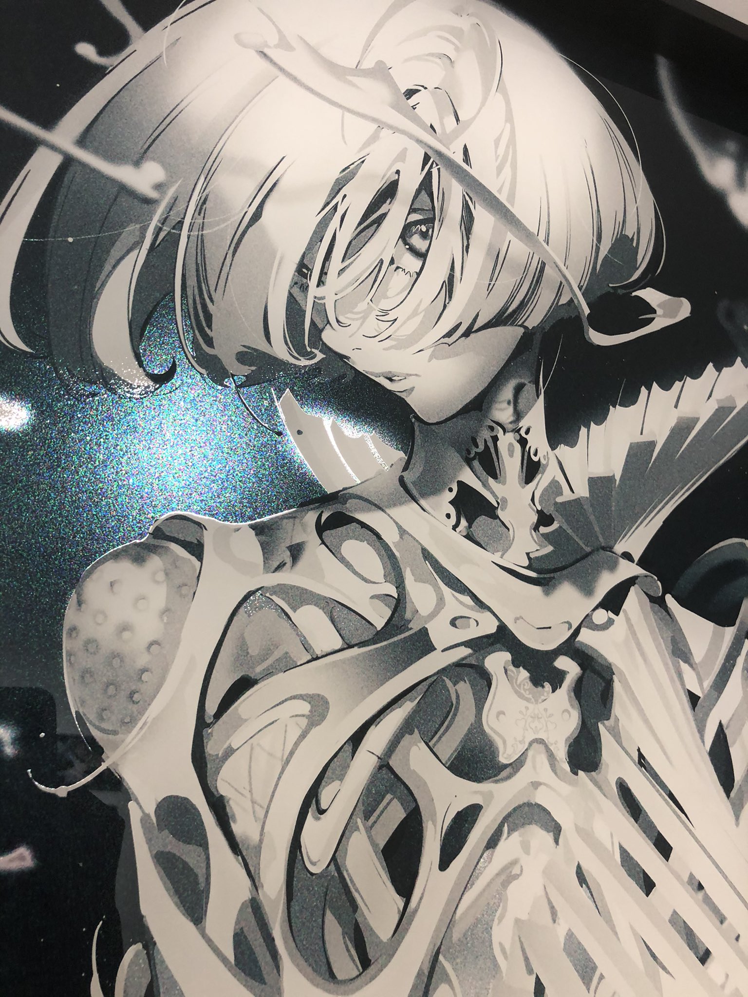 a closeup image of a grayscale drawing of a female cyborg with white hair, printed on a metallic paper.