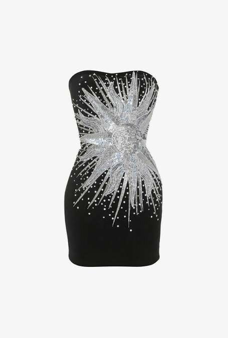 a strapless black cocktail dress with a sequin sunburst design on the front. the dress is fitted and hits above the knee. the sunburst design is silver and features a central circle with radiating lines. the background is white.