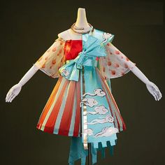 this is a picture of a colorful dress with an offtheshoulder neckline.  the dress is red and white stripes and it has a blue and white overskirt.  there is a large bow at the waist.  the dress has puffy short sleeves.  the dress is on a mannequin.