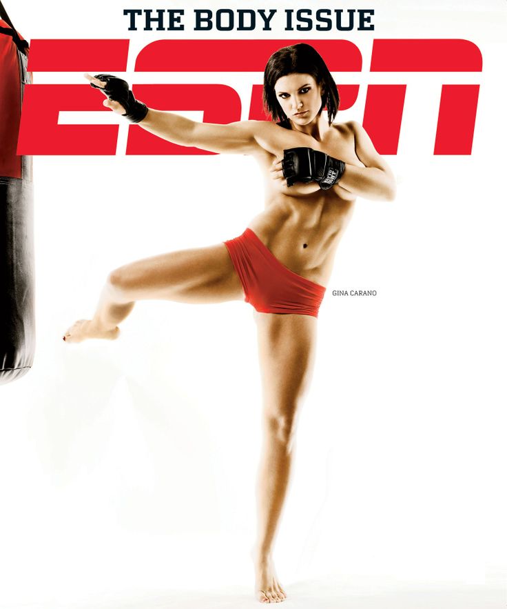 gina carano, a mixed martial arts fighter, is featured on the cover of espn magazine's body issue. she is kicking a boxing bag while wearing a red sports bra and shorts. she has a toned and muscular physique.  the magazine cover is in a white background with red and blue writing.