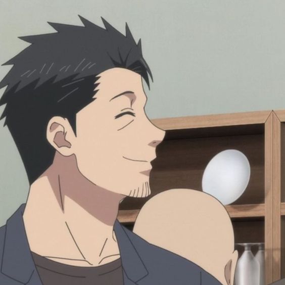 the image shows a closeup of an anime man with short, dark hair and a beard. he is smiling softly and looking to the right of the frame. the man appears to be inside, possibly in a restaurant, as indicated by the wooden shelves and white plate in the background. the lighting is soft and diffused. the image focuses on the man's facial expression, highlighting his happiness and contentment.
