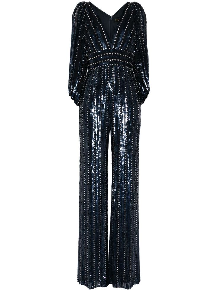 a navy blue sequined jumpsuit with long sleeves and a vneck. the jumpsuit has a wide leg and a fitted bodice. it is perfect for a party or a special occasion.