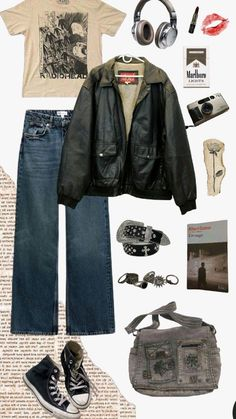 this image is a mood board showcasing a grungeinspired outfit. it features a beige tshirt with a band logo, a black leather jacket, a pair of darkwash jeans,  converse sneakers, and a grey satchel bag. the accessories include a silver belt with studs, headphones, a camera, a book, a pack of cigarettes, and a lipstick. the overall style is edgy and cool, with a punk aesthetic.