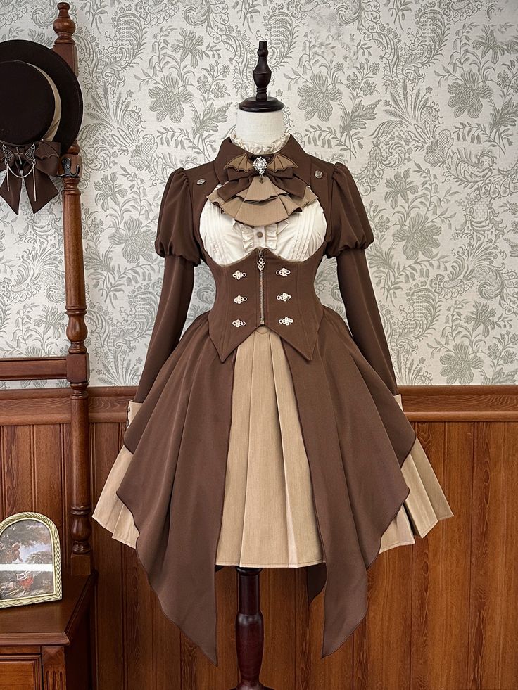 a brown and beige lolita fashion dress is shown on a mannequin. the dress has long sleeves, a highwaisted skirt, and ruffles. it is styled with a bow and a militaryinspired jacket. the background is a floral wallpaper and a wooden floor.