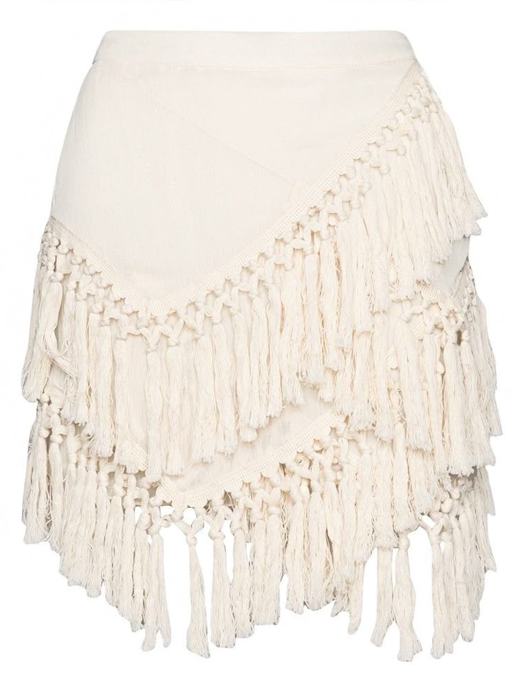 a white skirt with tiered fringe and tassel details is shown in the image. the skirt has a solid white base with multiple layers of fringe and tassels cascading down. the overall design is bohemian and textured.