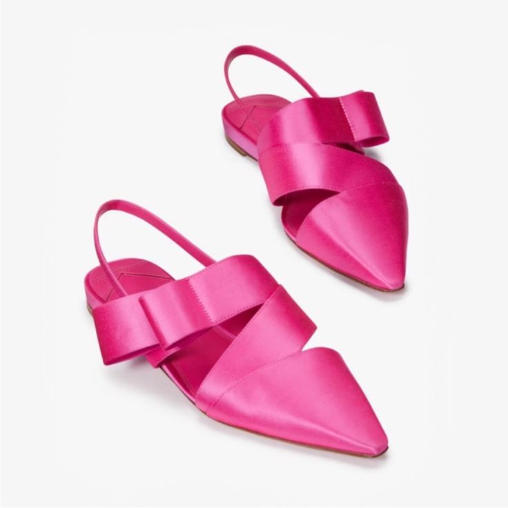 a pair of hot pink satin slingback shoes with a pointed toe. the shoes are laid out on a white background. the shoes are stylish and elegant, and would be perfect for a summer or spring occasion.