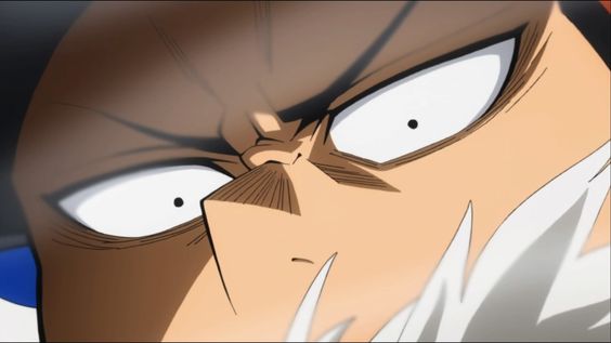 a closeup of a man's face. he has a serious and intense expression with wide eyes and a furrowed brow. his face is partially obscured by white streaks, likely from movement or an effect. the color palette is warm, with browns and tans dominating the image.
