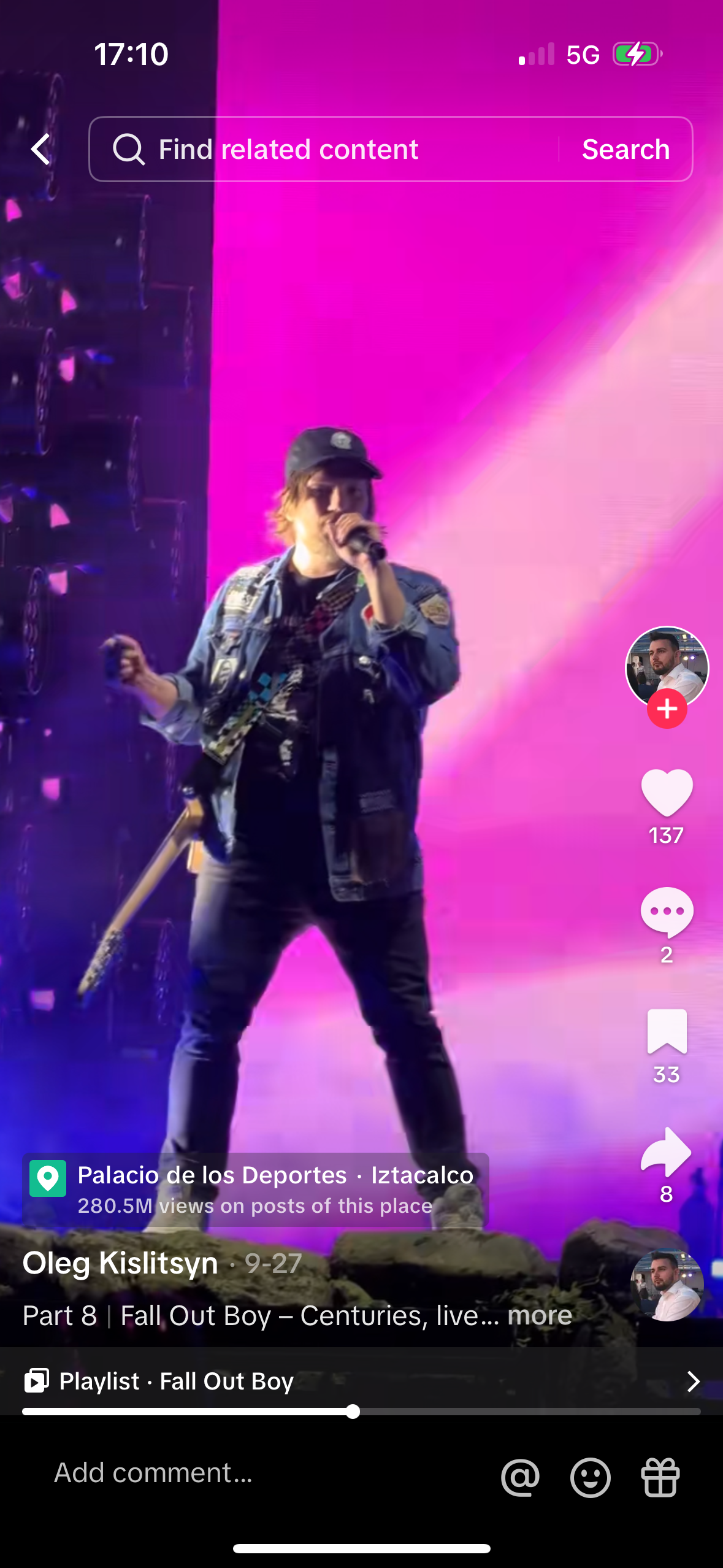 a still from a music video featuring oleg kislitsyn, who appears to be singing into a microphone while holding a guitar. the concert appears to be taking place at palacio de los deportes in iztacalco, mexico. the image has instagram and tiktok interface elements such as views, likes, comments, and shares.