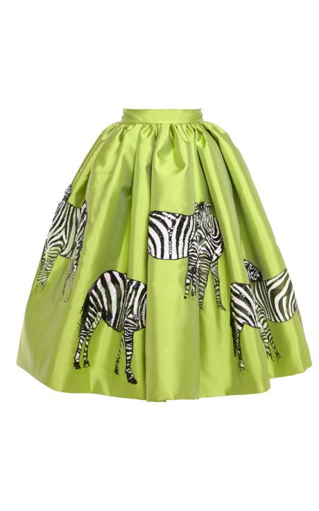 a green midi skirt with a zebra print is displayed against a white background. the skirt has a gathered waist and an aline shape. the zebra print features black and white zebras in various poses scattered around the skirt.