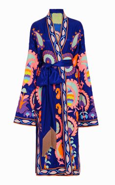 a luxurious blue silk robe with floral embroidery in a variety of bright colors. the robe is longsleeved and features a wrap closure. it is a feminine and elegant garment.