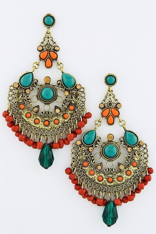 a pair of gold, teal, and red dangle earrings. the earrings have a large, ornate design with a large teal gemstone in the center of each earring. the earrings are also adorned with small red beads and teal beads. the earrings are a beautiful and unique piece of jewelry.