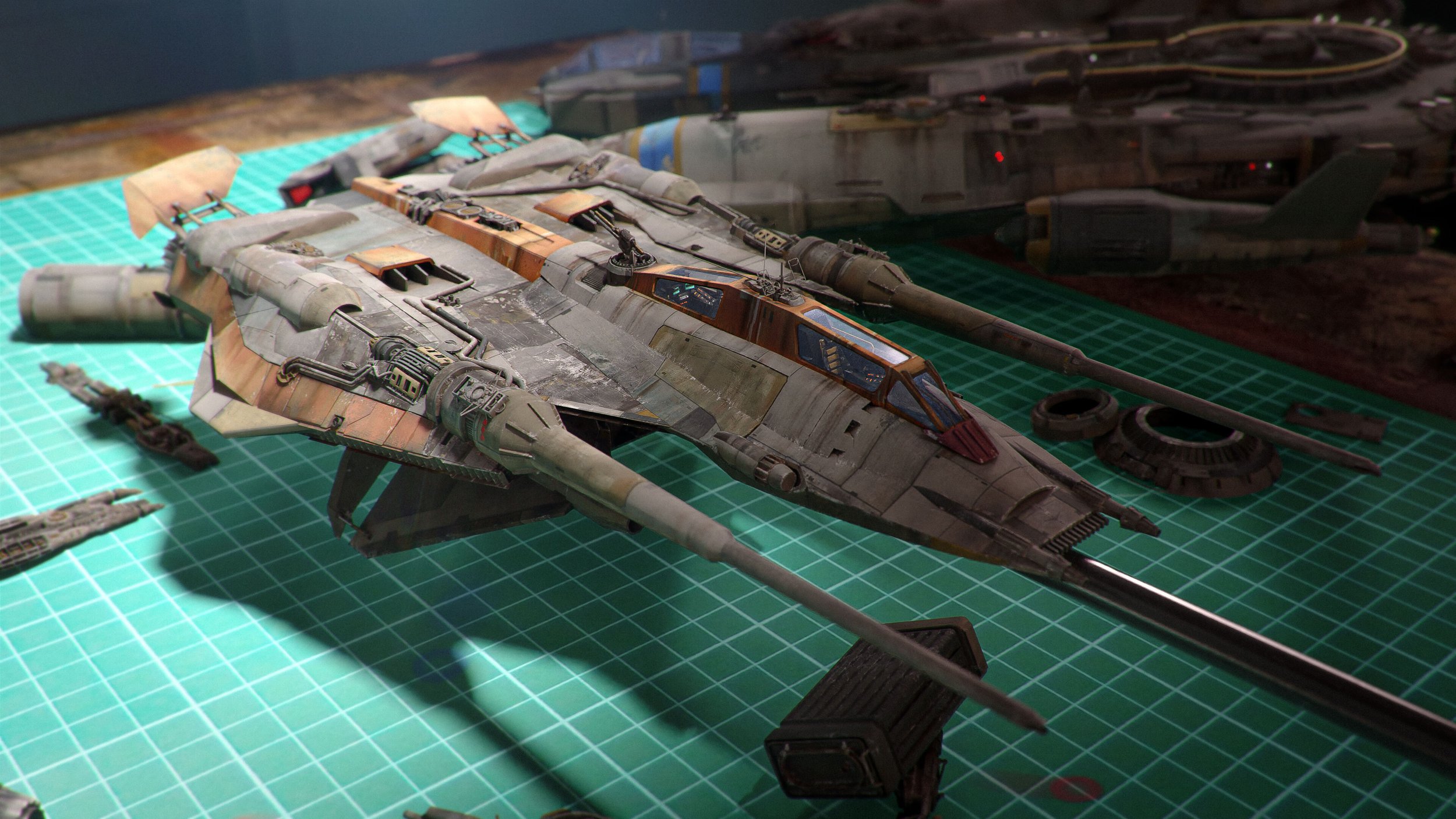 the image showcases a meticulously detailed model of a spaceship, possibly a uwinginspired design given its style. it's resting on a green cutting mat, and several smaller parts are scattered around it, suggesting it might be a workinprogress model kit or a diorama. the model displays advanced weathering techniques to give it a realistic, used appearance. the background shows another, larger, less detailed spaceship model, possibly in the process of being constructed or completed. the overall aesthetic leans towards science fiction, with potential connections to the star wars universe due to the design cues.  the scene suggests a hobbyist's workspace.