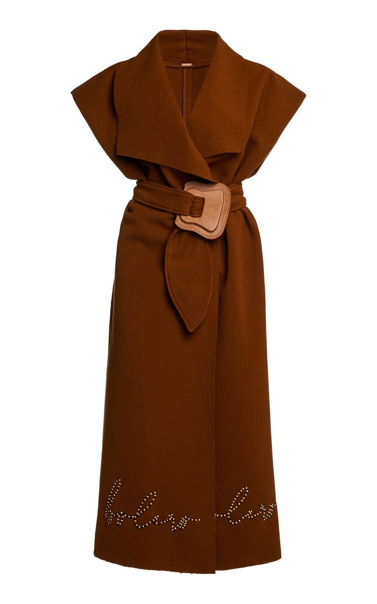 a brown sleeveless dress with a belt, buckle, collar, embroidery, and writing on it.
