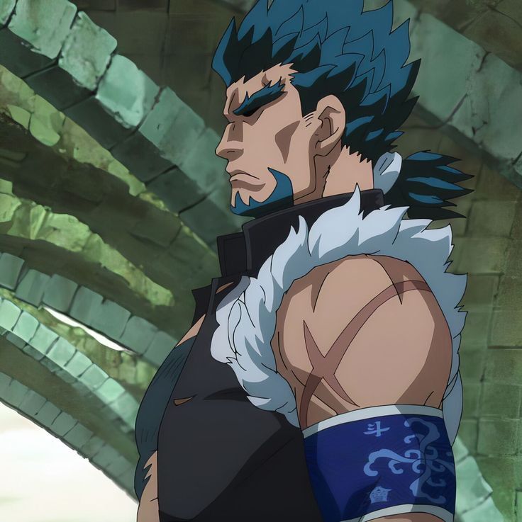 the image shows a muscular, bluehaired man with a serious expression. he has a short beard and noticeable scars on his arms and face. he wears dark clothing with fur accents and a blue armband with a white design. he stands within a stone building with arched doorways.