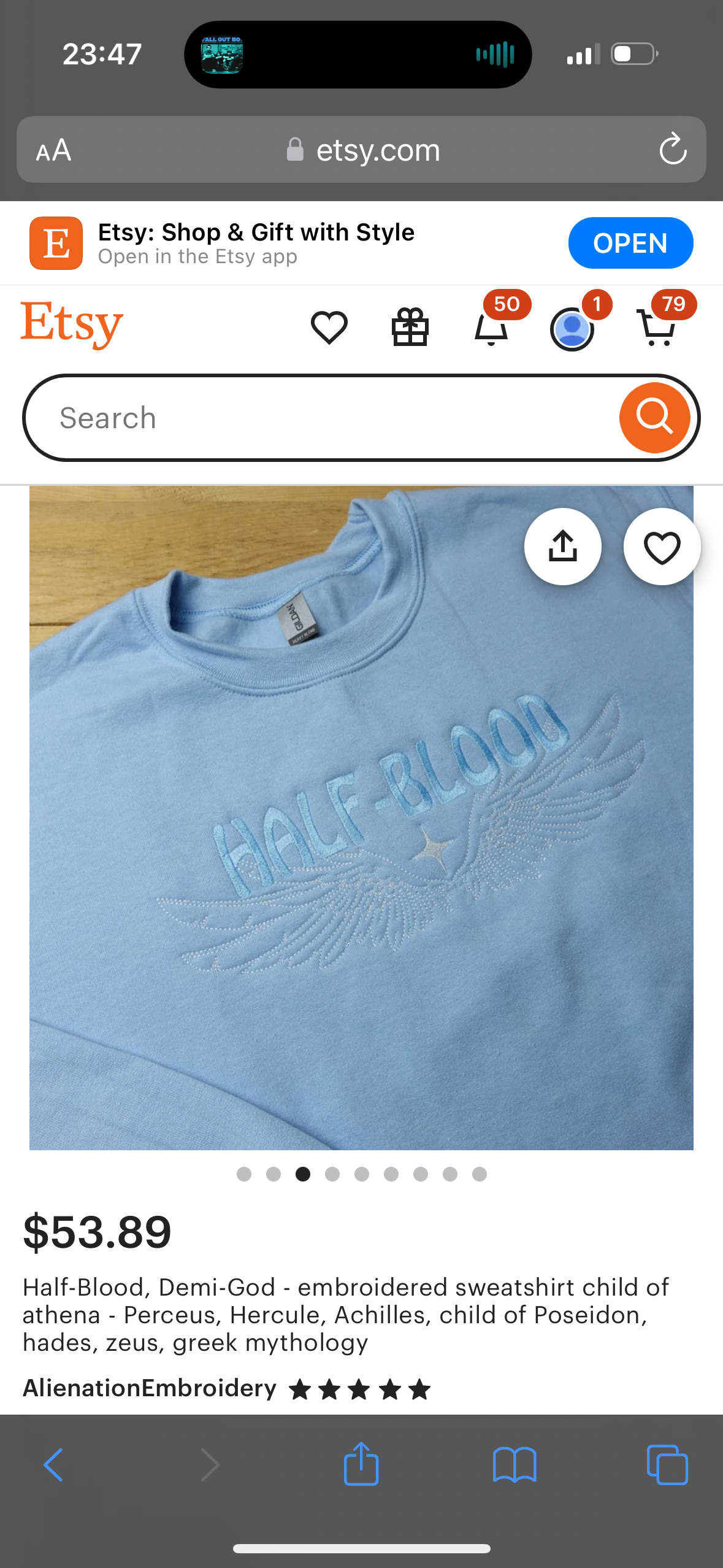 a blue halfblood embroidered sweatshirt  is being sold on the etsy app. the product description highlights the demigod  characters from greek mythology. the price is $53.89. the screenshot also includes a few  buttons that can be used to share, save, or open the product.  the image of the sweatshirt is shown on a white background.