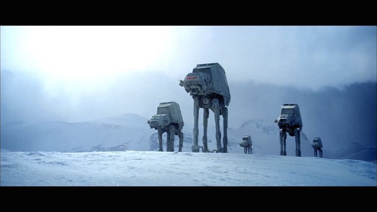 a wide shot of four atat walkers from star wars, standing on a snowy mountain landscape. the walkers are the main focus, positioned in the middle ground with the snowy mountains forming a vast backdrop. the sky is overcast, and the overall scene is quite cold and desolate, evoking a sense of a battle or impending action. the image is reminiscent of iconic scenes from the star wars saga.