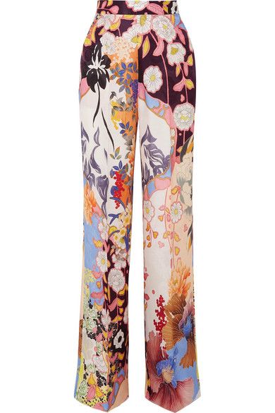 a pair of women's wideleg trousers are shown in the image. the pants are highwaisted and have a vibrant, multicolored floral print.  the print is a mix of various flowers and patterns, creating a bohemian or eclectic feel. the pants appear to be made of a lightweight, possibly silk or linen material, suitable for warmer weather.  they are a statement piece, perfect for adding a touch of style and personality to any outfit.