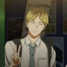 a blonde anime boy in a white shirt and teal striped tie smiles gently at the viewer while making a peace sign with his right hand. he has a brown bag slung over his shoulder. the background suggests he is inside a school hallway, with lockers and posters visible. the lighting is warm and soft, creating a friendly and approachable atmosphere.