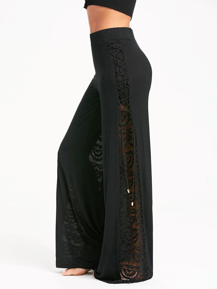 a woman wearing black wideleg pants with lace and laceup details down the side.