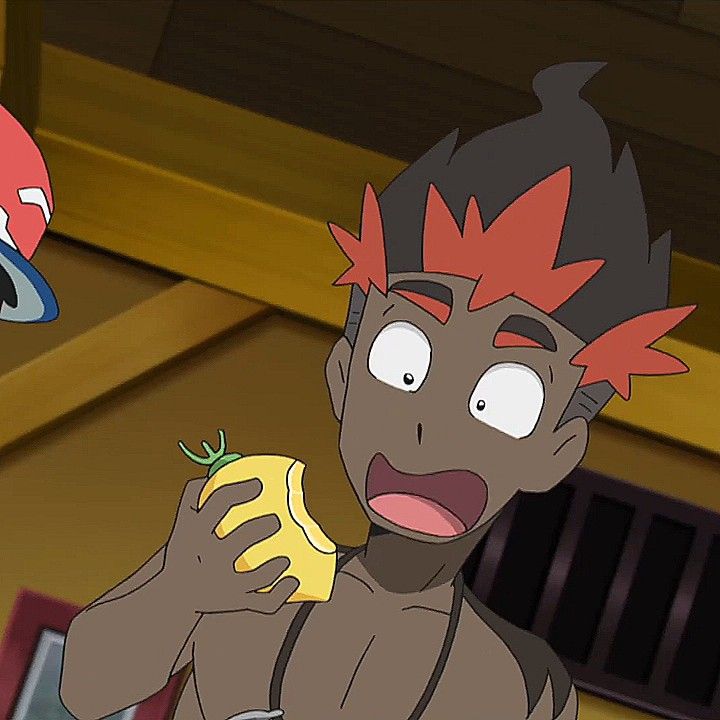 this is an anime cartoon image of a male character with brown skin and red hair. he is shocked and surprised with his mouth wide open, his eyes wide. he is holding a yellow fruit in his hand and eating it. the character looks like he has a  red hair, with a black top layer over it. he has black eyes and his overall appearance seems to be a mix of brown and reddish color.