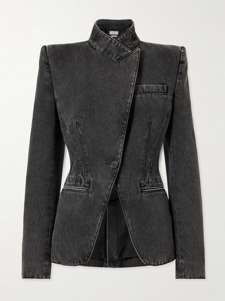 a black denim blazer with a tailored fit and a collar that's folded over. the blazer has a single button closure and pockets on either side. the fabric is distressed and faded. the blazer is being worn by a model in a studio photoshoot.