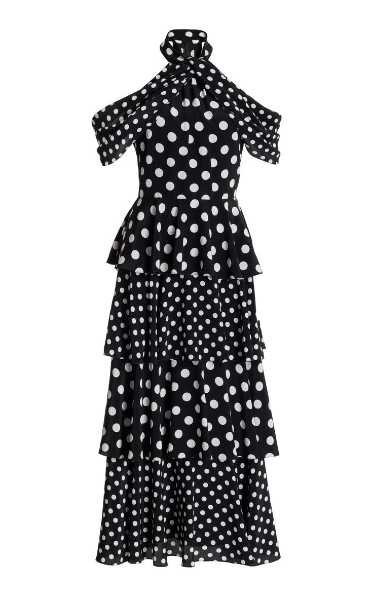 a black and white polka dot dress with a halter neckline, cold shoulders, and a tiered skirt. the dress is ruffled and has a midi length.