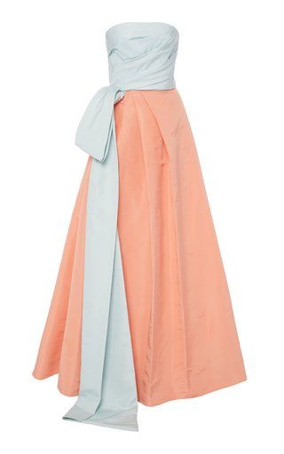 an anklelength, light peach strapless dress with a light blue sash tied at the waist.
