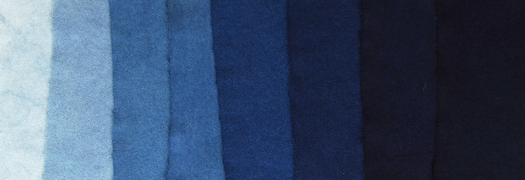 an image of fabric swatches in different shades of blue arranged in a gradient.