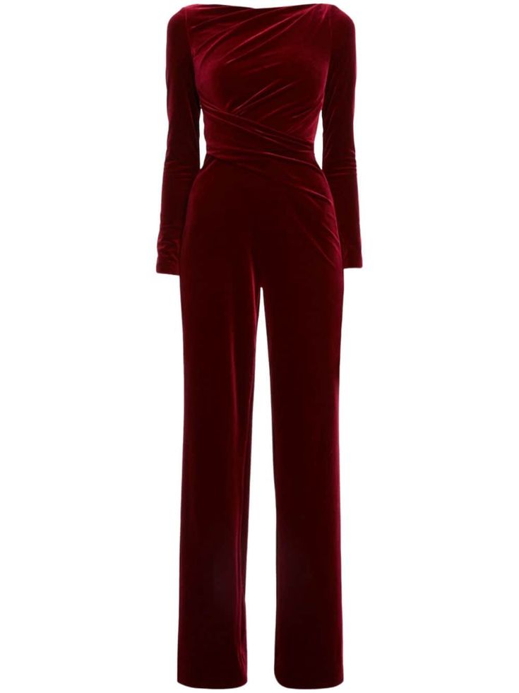 a beautiful women's red velvet jumpsuit with long sleeves and a wide leg. the jumpsuit is elegant and formal, making it perfect for a party or other special occasion.