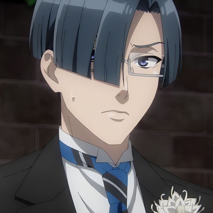 the image showcases a closeup portrait of a young anime man. he has short, dark blue hair styled with a fringe covering one eye. he wears a black eyepatch over his right eye and has a serious expression. he is dressed in a formal black suit with a white shirt and a blueandwhite striped tie. a white flower adorns his lapel. the background suggests an indoor setting with a red brick wall, lit with soft artificial light.