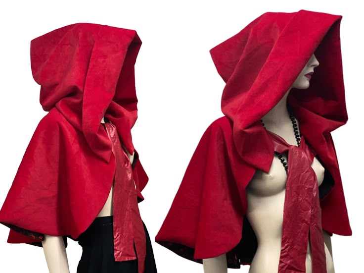 two mannequins are wearing red velvet hooded capes. the capelets have ties at the front. the mannequin on the right is also wearing a black beaded necklace. the capes are lined in black.