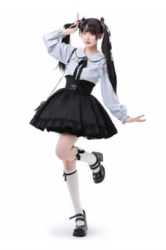 a young girl in a cute lolita outfit poses with a happy smile, showing off her black skirt, white blouse, and black shoes. she has her hair in pigtails and is wearing cute accessories. the image was taken in a studio setting.
