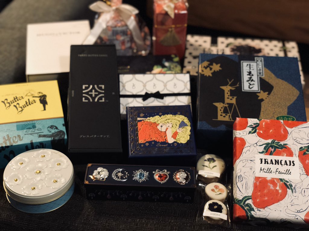 a variety of beautifully wrapped gift boxes and chocolates are arranged on a dark surface, suggesting a celebration or special occasion like valentine's day.