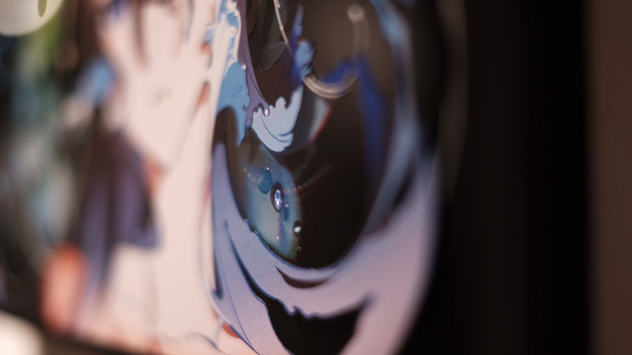 this is an abstract image with swirls of blue, white, and black. the center of the image appears to resemble an eye with blue iris looking directly at the viewer.