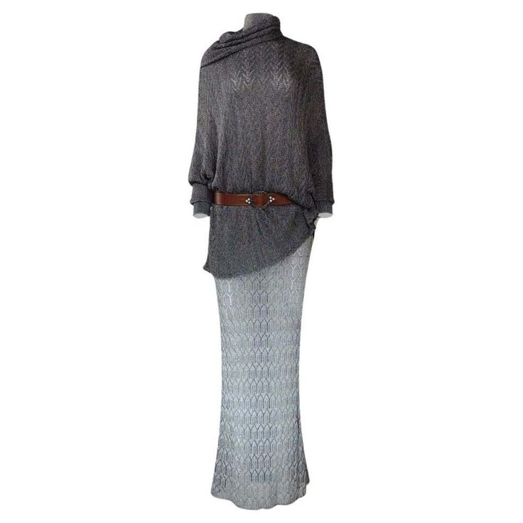 a gray cowl neck sweater with long sleeves and a brown belt is shown on a mannequin. the sweater is paired with a gray, knit skirt.  the outfit is stylish and casual.