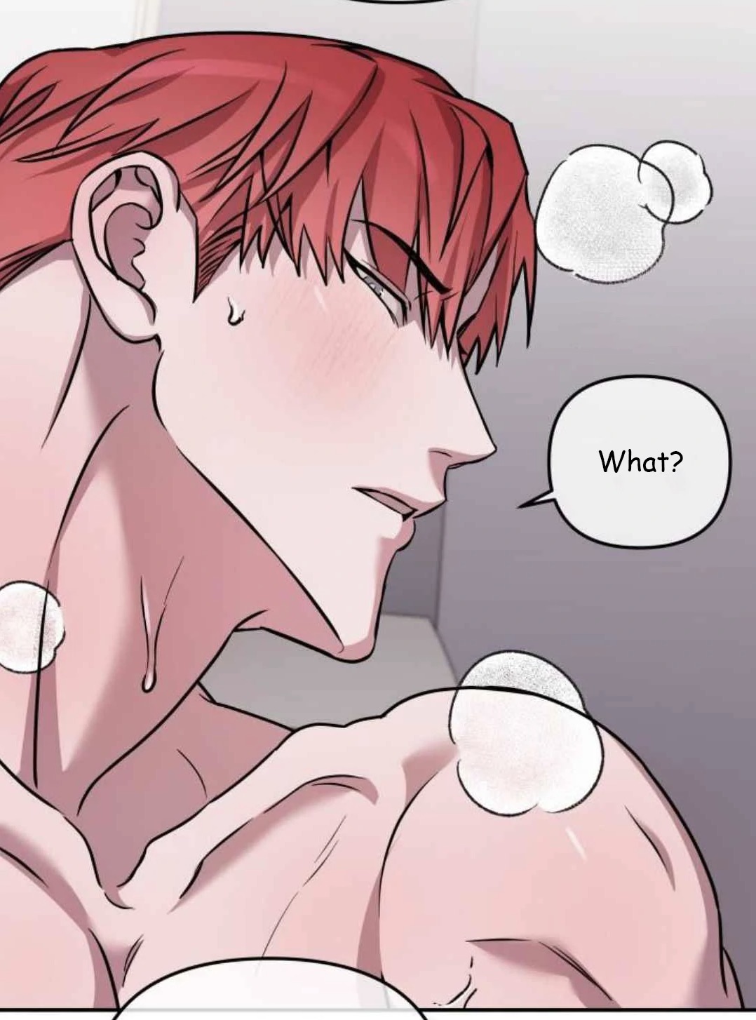 the image is a closeup panel from a manhwa (korean comic) or manga (japanese comic), likely in the bl (boys' love) or yaoi genre.  it depicts a muscular man with bright red hair, partially shown from the neck up, appearing to be in the shower.  soap suds are visible on his shoulder and neck. he has a surprised or slightly confused expression, with a blush on his cheeks. a thought bubble above him reads "what?". the art style is characteristic of manhwa, with clean lines, a somewhat softer color palette, and a focus on character expression. the overall tone is intimate and suggestive.