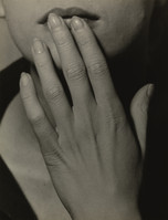 the image is a closeup black and white photograph of a woman's face and hand. her hand is gently raised to her mouth, partially covering her lips.  the focus is sharply on the hand and the texture of the skin is clearly visible, showing fine lines and details. the woman's expression is ambiguous, suggestive of contemplation or perhaps sadness. the lighting is dramatic, creating subtle shadows that enhance the mood of the photograph. the overall style is reminiscent of classic portrait photography, with a strong emphasis on the texture and emotion conveyed through the subject's pose and the photographer's choice of lighting and composition.
