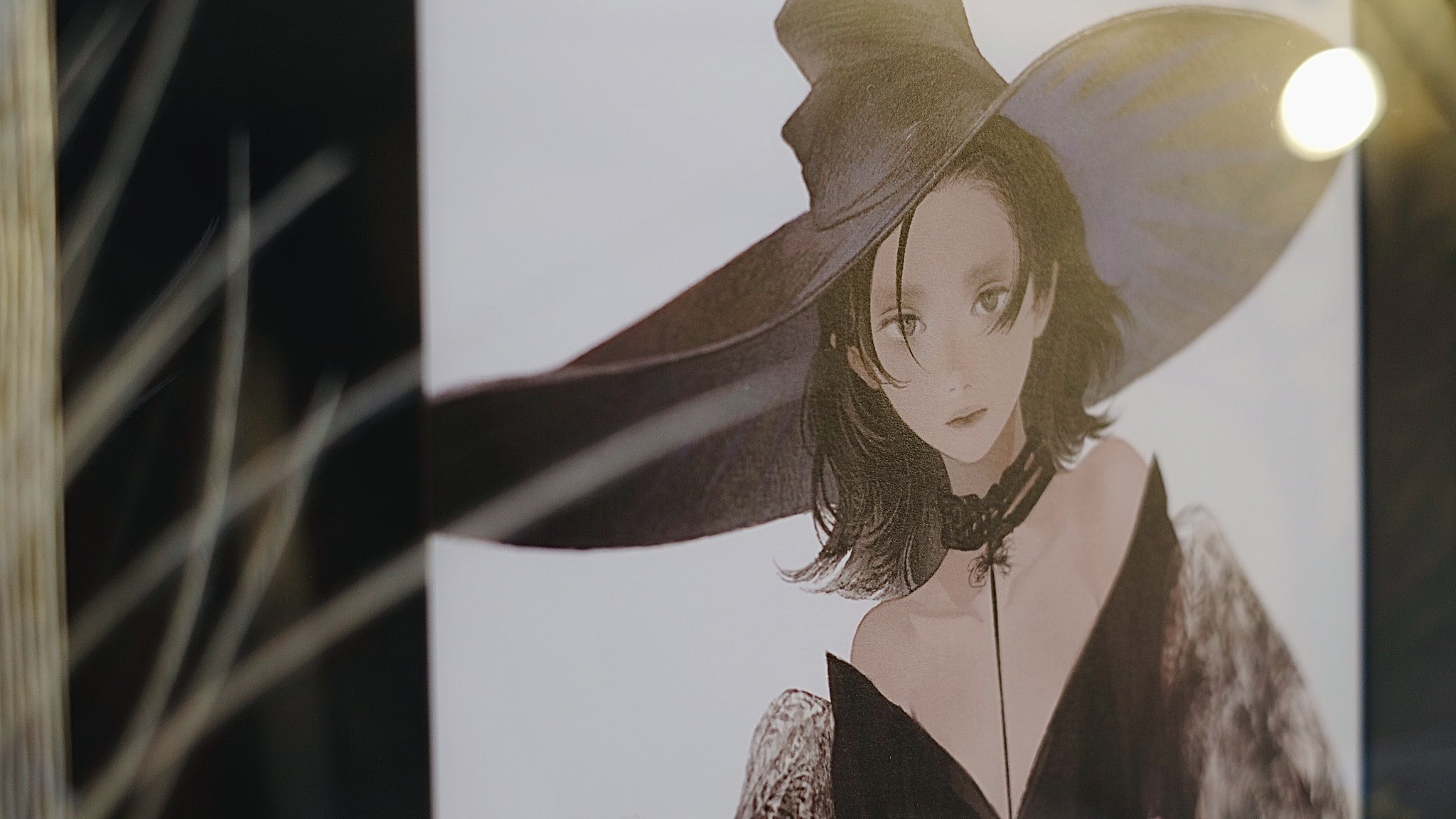 the image is an illustration of a woman wearing a witch's hat. she is wearing a black dress with a deep vneckline and a choker necklace. her hair is dark and falls in waves around her shoulders. her expression is serious. the background of the image is white. the image is framed in a black frame. the image is lit from the side, creating a soft shadow on the woman's face.