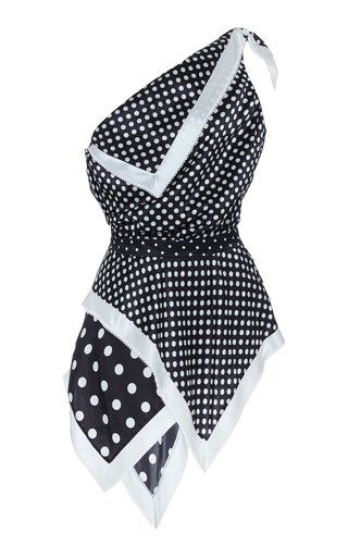 a black and white polka dot sleeveless top with a white trim and one shoulder design is shown.
