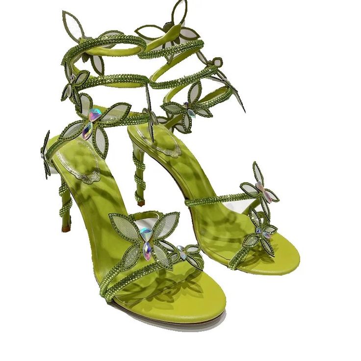 a pair of lime green highheeled sandals adorned with intricate butterflyshaped embellishments. the butterflies are encrusted with sparkling crystals and rhinestones, adding a glamorous touch to the shoes. the heels are stiletto style, and the sandals have a delicate, elegant design, perfect for special occasions or a stylish evening out. the sandals are shown against a white background, enhancing their vibrant color and intricate details.
