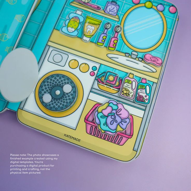 an overhead shot shows a paper dollhouse laundry room scene. the scene includes a washing machine, laundry basket filled with clothes, and various laundry supplies on shelves. the scene is colorful and cartoonish. a note at the bottom clarifies that it's a digital template, not a physical item.