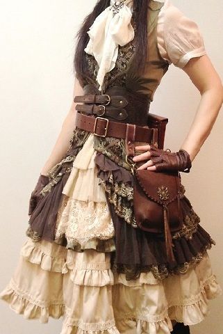 a woman is wearing an elaborate steampunkinspired dress. the dress is made of brown and cream fabric, with layers of lace and ruffles. she has a brown leather belt with multiple buckles around her waist, and a brown leather pouch hangs from her hip. she is also wearing brown leather gloves. the woman is standing in front of a white wall, and the lighting is soft and diffused.