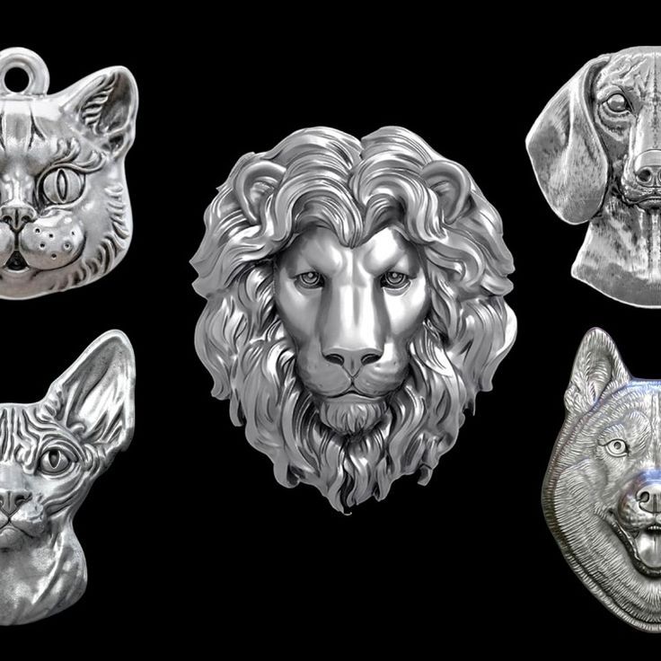 the image shows a collection of silver animal pendants including a lion, two cats, a dog, and a wolf. they are arranged against a black background.