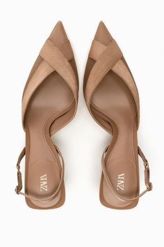 a pair of brown heeled women's sandals with the "zara" logo on the inside of each shoe.