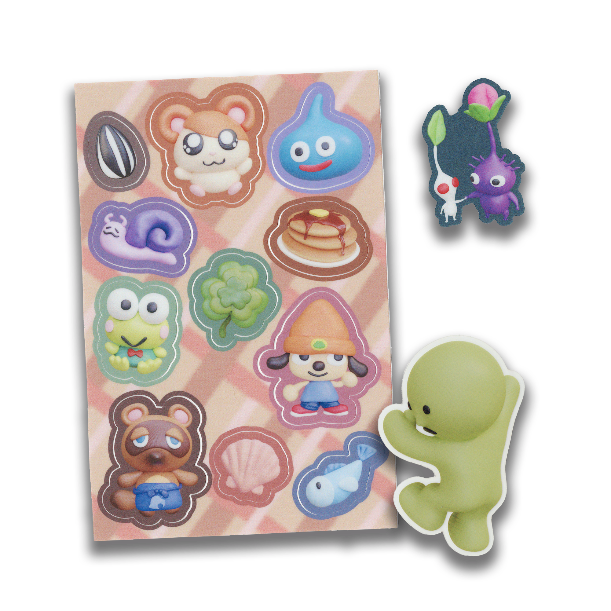 a sheet of colorful animal crossing stickers. the stickers show characters such as tom nook, kirby, a snail, a clover, a fish, and pacman. the stickers are arranged in a grid pattern on a pink background.