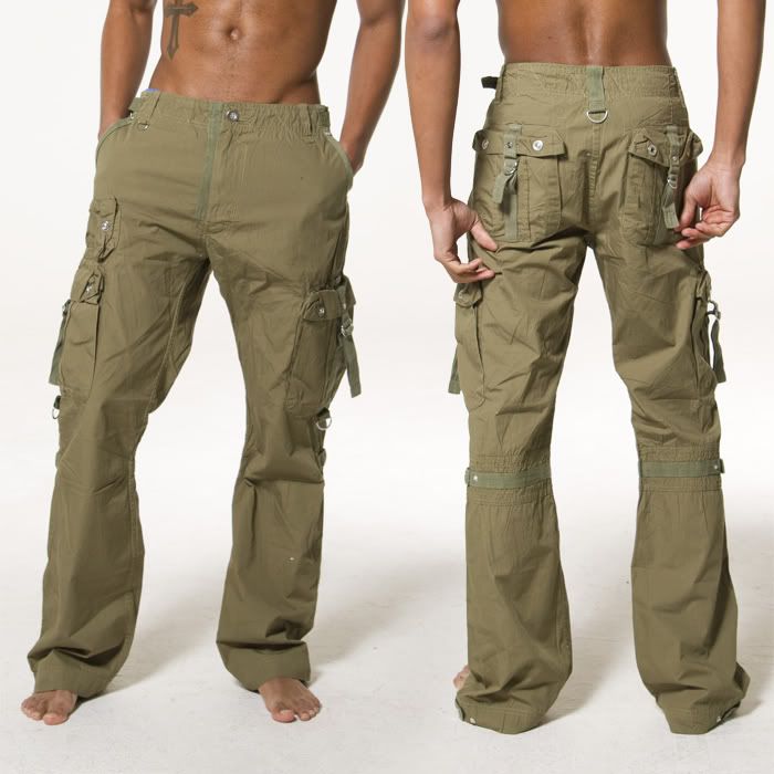 two men are wearing the same style of olive green cargo pants. the pants have many pockets and a belt with decorative buckles.  they are standing in a studio with a white background, one man facing forward, the other facing the side.