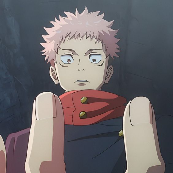 a young, pinkhaired anime character is shown from the chest up, looking surprised and slightly fearful. the perspective is from below, as if someone is reaching towards him. he wears a dark outfit with a red collar. the background is a dark and blurry gray.