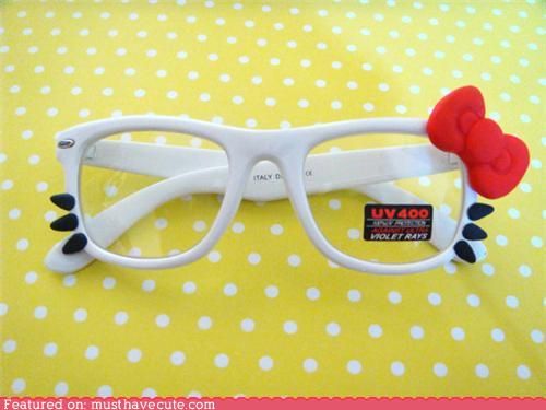 a pair of whiteframed eyeglasses designed to resemble hello kitty rests on a yellow polka dot background. the glasses have a large red bow attached to one side and black whiskers on both sides. a uv400 protection sticker is affixed to the lens.