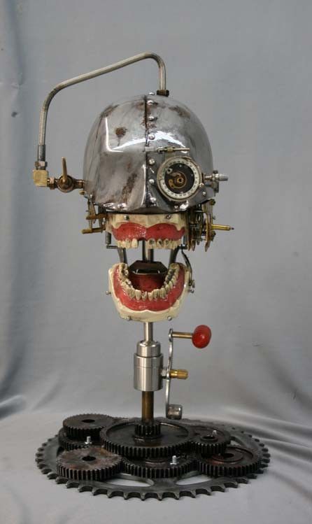 a closeup of a steampunk robot head with gears and cogs. it has a metal helmet with a clock face on one side and a mouth full of teeth on the other. the head is mounted on a base of gears and cogs. it is a unique and detailed piece of artwork.