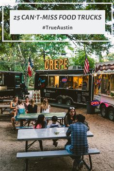 a photo of a group of people enjoying a meal at a picnic table in front of two food trucks, including a crepe truck. the photo is taken from a slight angle, and there is greenery and trees in the background.